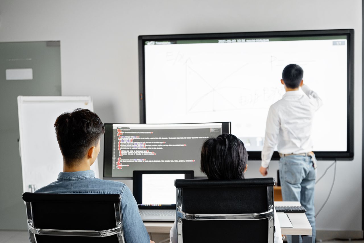Home Team conducting a business presentation with technology in a modern office setting.